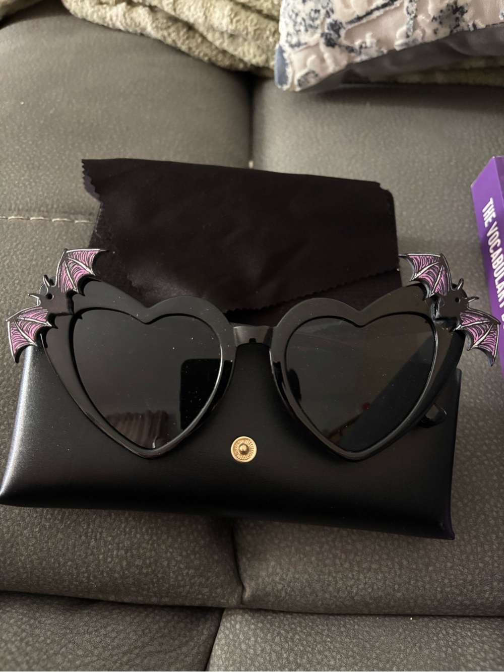 Heart-Shaped Black Sunglasses with Purple Bat Wing Accents